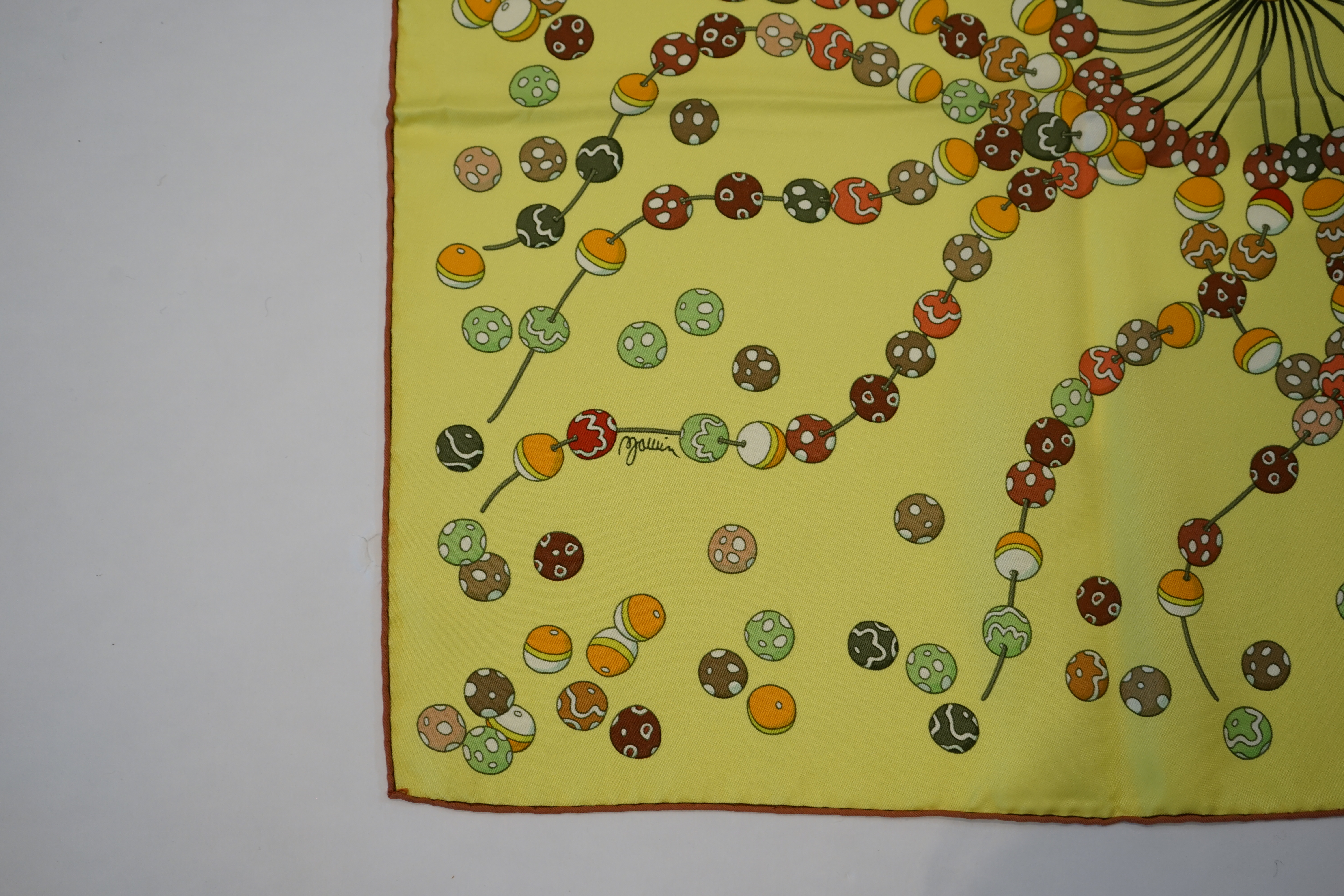 A yellow Hermès 'Dancing Pearls' silk scarf designed by Virginie Jamin, 90cm x 90cm